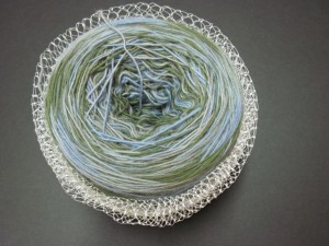 Corral fine lace weight yarn in an elastic-like mesh cradle