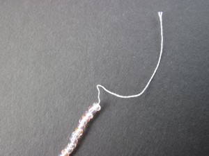 Loosen a strand from the knotted bundle