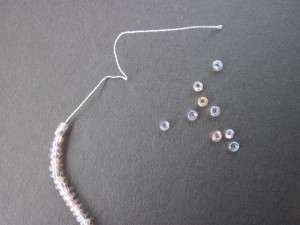 Remove a few beads if necessary to make space on the string