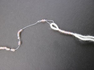Slide beads onto project yarn/thread
