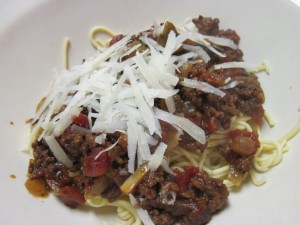 Fresh spaghetti with homemade meat sauce and freshly grated parmesan