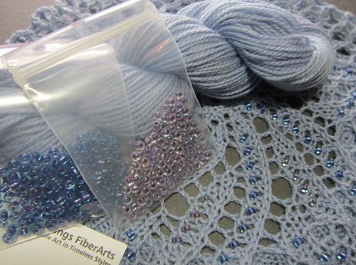 Yarn and beads to make your own version of a Beaded Lace Doily Beret