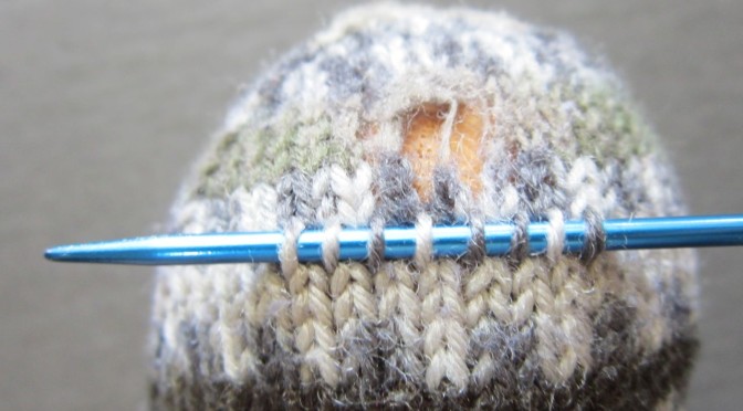 Repairing a hand-knit sock with a knit-in-place patch